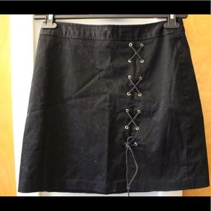 Black mini skirt w/ lace-up detail, slit. Size 4.